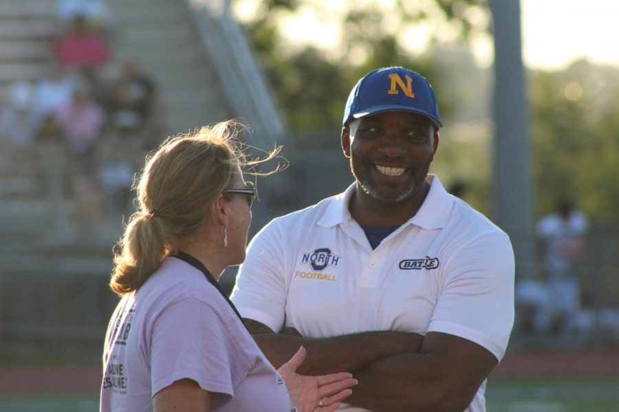 Johnson laughs on the sidelines of the varsity football game against Burke with co-worker Melinda Bailey.
Photo by Caitlin Pieters