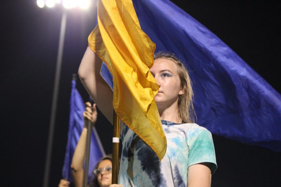 Lyndsey Bateman, 11, holds the flag for the North High Color Guard at the game on September 14. 
Photo by Caitlin Pieters