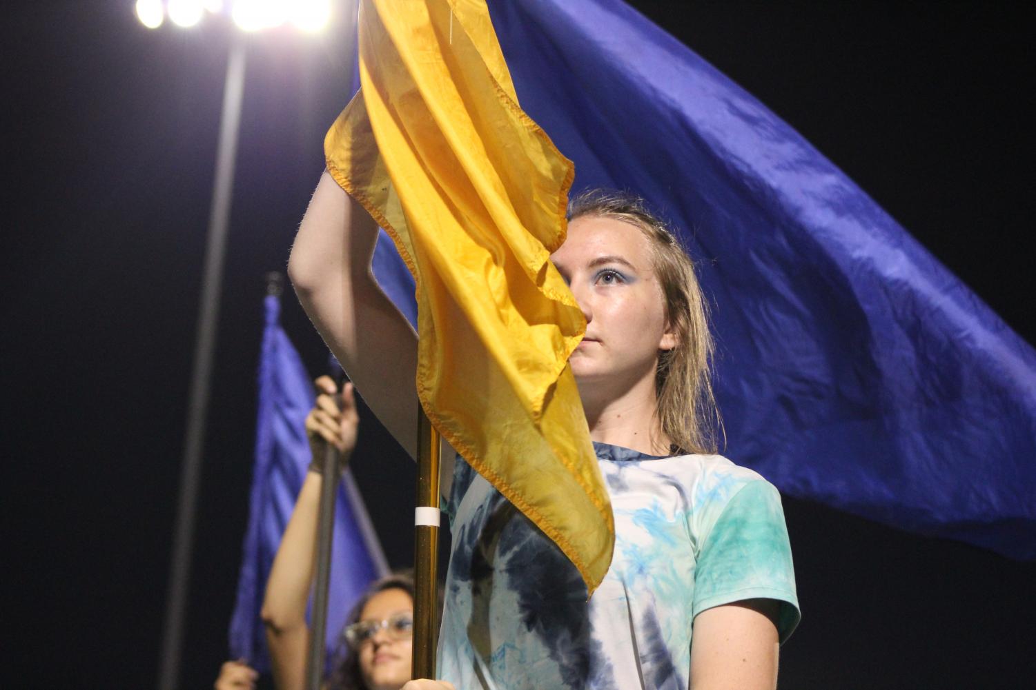 Lyndsey Bateman, 11, holds the flag for the North High Color Guard at the game on September 14.
Photo by Caitlin Pieters