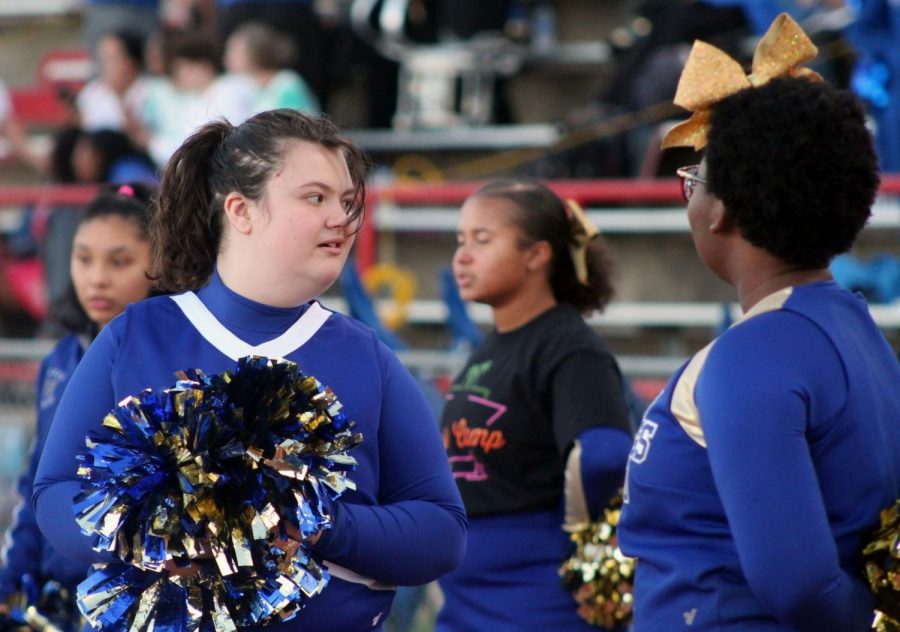 Sparkle cheerleader cheers at the homecoming game. The sparkles wear blue and gold to show their school spirit.
Photo by Caitlin Pieters