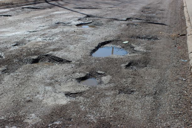 A cluster of potholes formed on 36th street just south of Ames. This section of the 36th is used by many student, parents, teachers and bus drivers to get in and out of the Omaha North High parking lot.
Photo by Zach Hansen