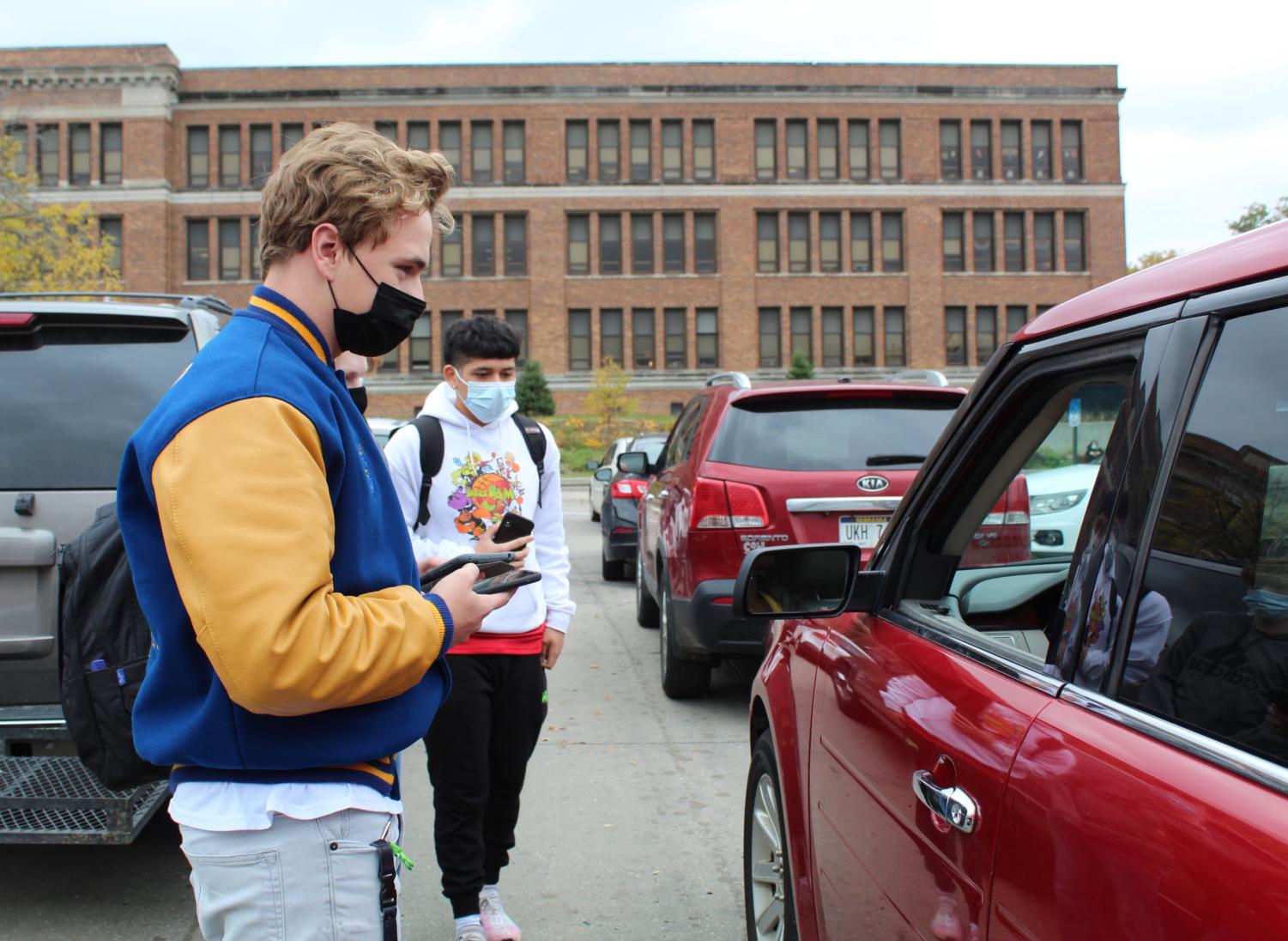 Caiden Williams, 12, surveys parents in the parking lot for his Engineering and Design capstone project. Williams hopes to implement his capstone at North in the future.